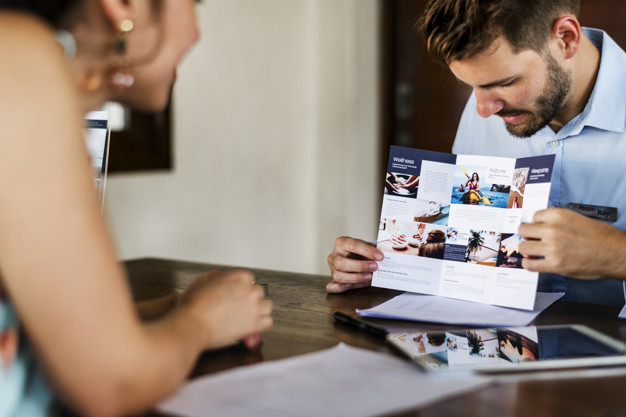 Man showcasing a hotel brochure