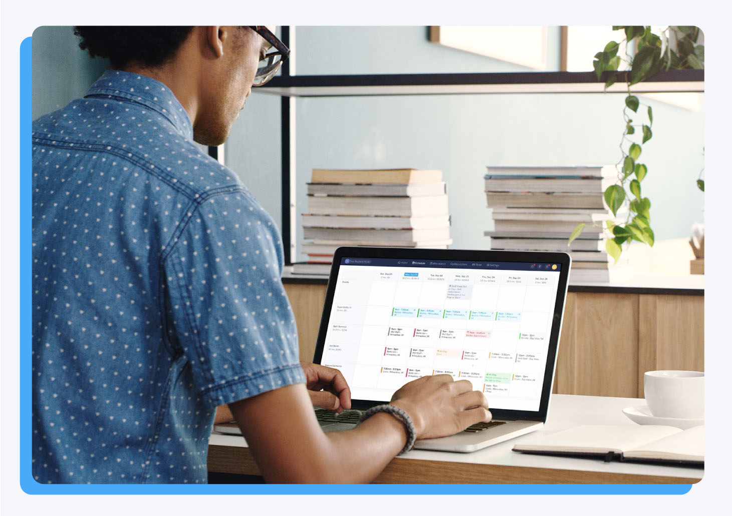 Man working on a computer with an employee management software